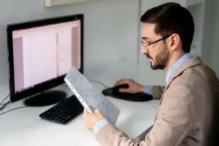 Inginer analizand atent masuratorile topografice