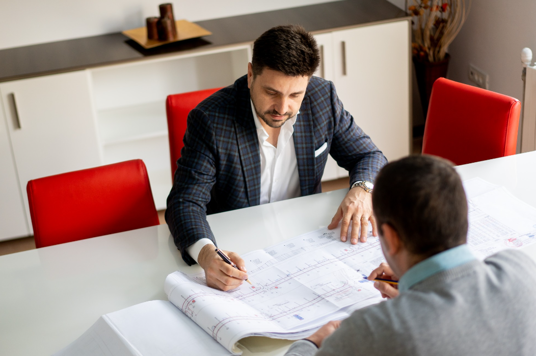 Dromcons engineers analyzing road bridge plans at the design table