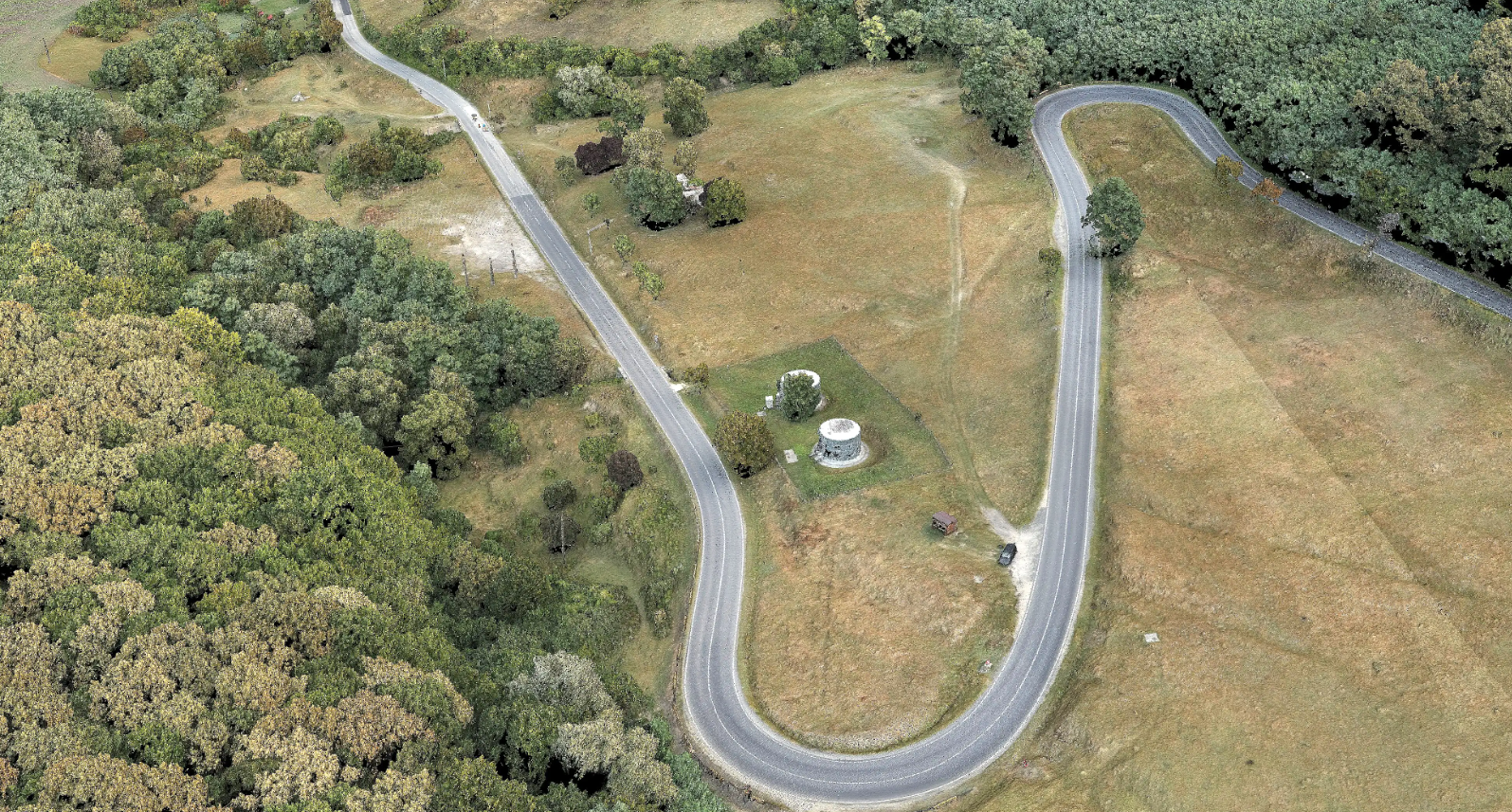 Modern winding road built by Dromcons in a forested area of western Romania