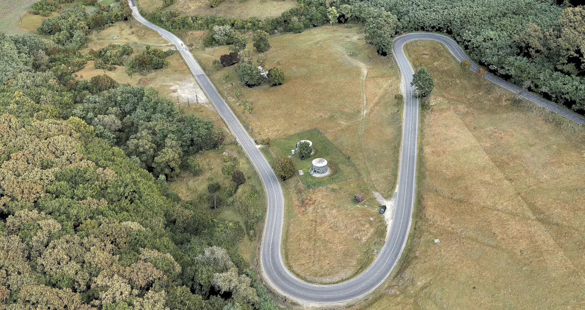 Aerial view of a winding road and green areas within the DN14A Blăjel project